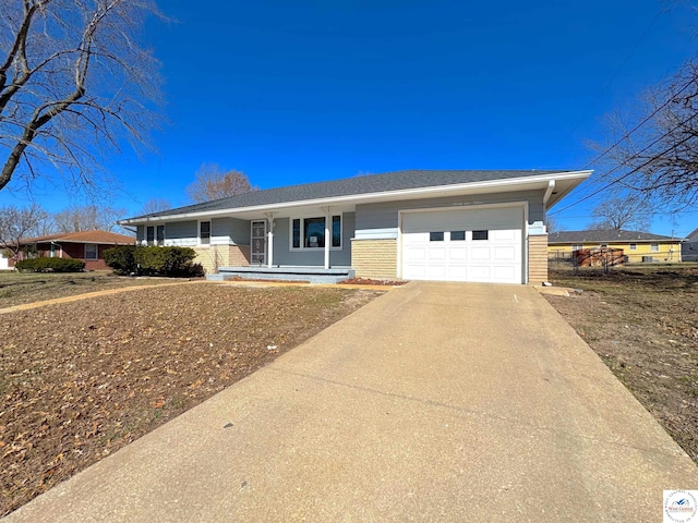 single story home featuring a porch, a shingled roof, concrete driveway, a garage, and brick siding