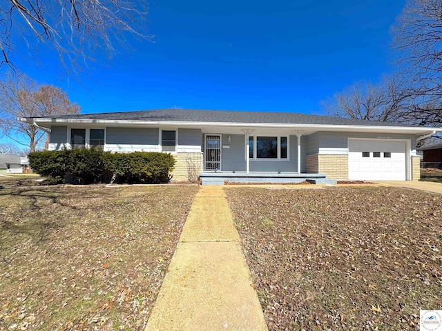 single story home with an attached garage, covered porch, and brick siding