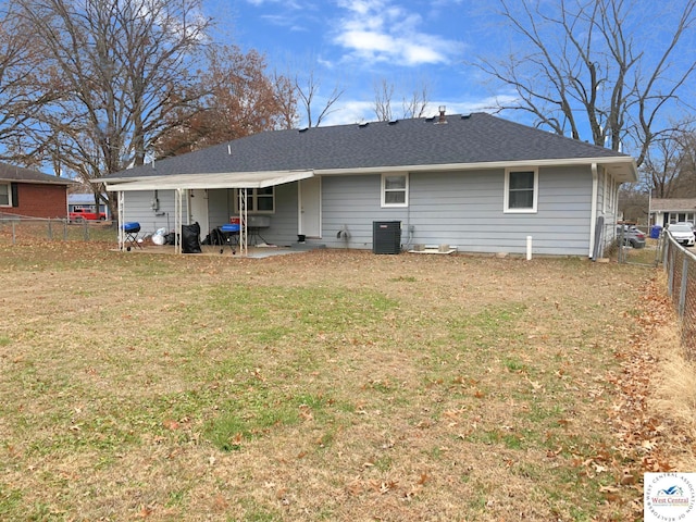 back of property featuring a patio, central AC unit, a lawn, and a fenced backyard