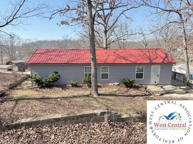 view of side of property with metal roof