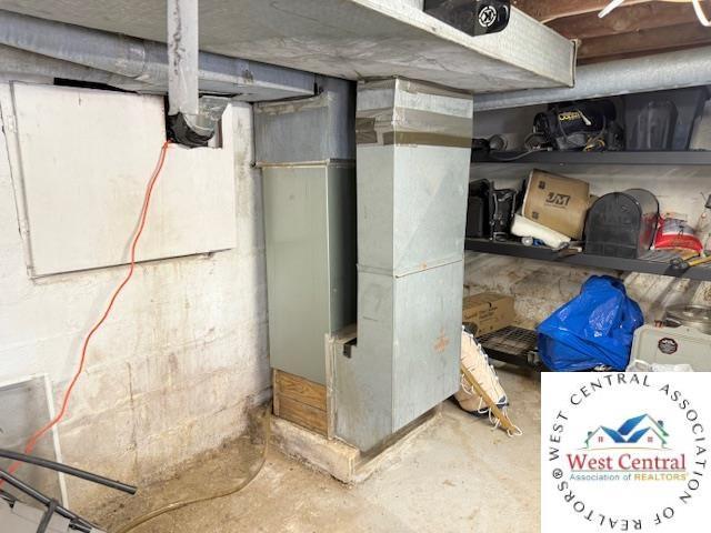 unfinished basement featuring heating unit