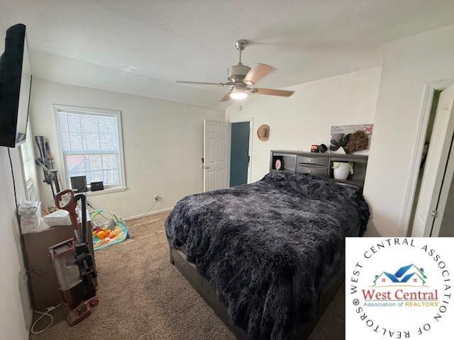 carpeted bedroom with ceiling fan