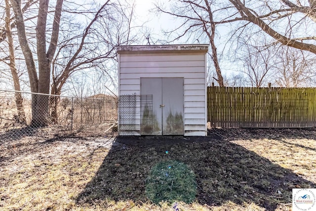 view of shed featuring fence