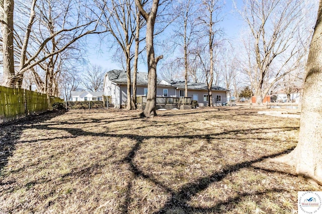 exterior space featuring a lawn and fence