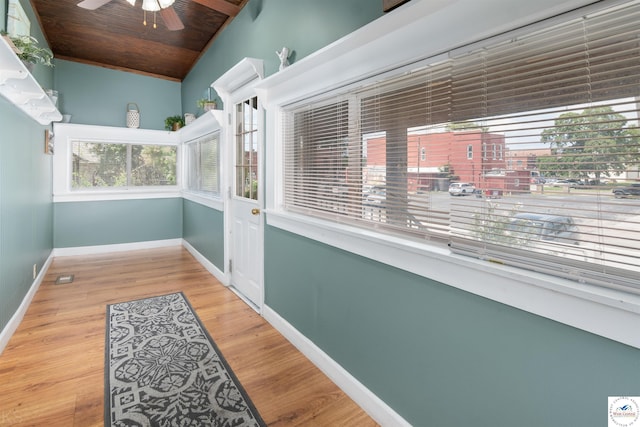 sunroom / solarium featuring a ceiling fan, lofted ceiling, wooden ceiling, and visible vents