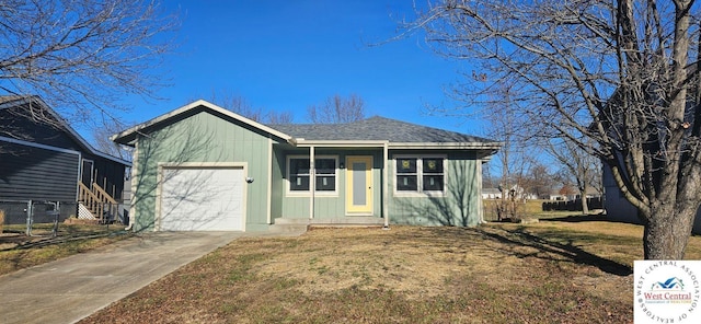 view of front of property featuring a garage, concrete driveway, and a front yard