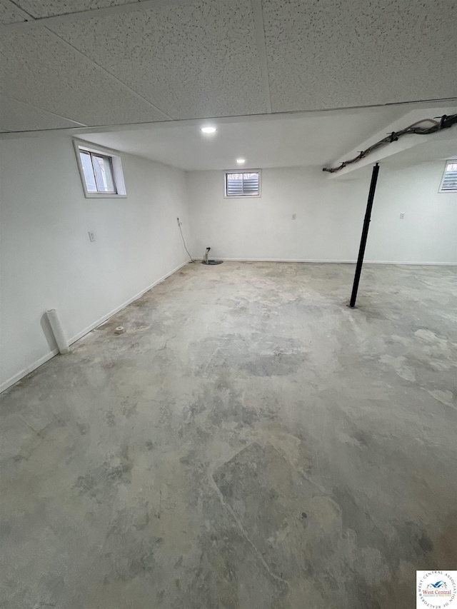 basement featuring a drop ceiling