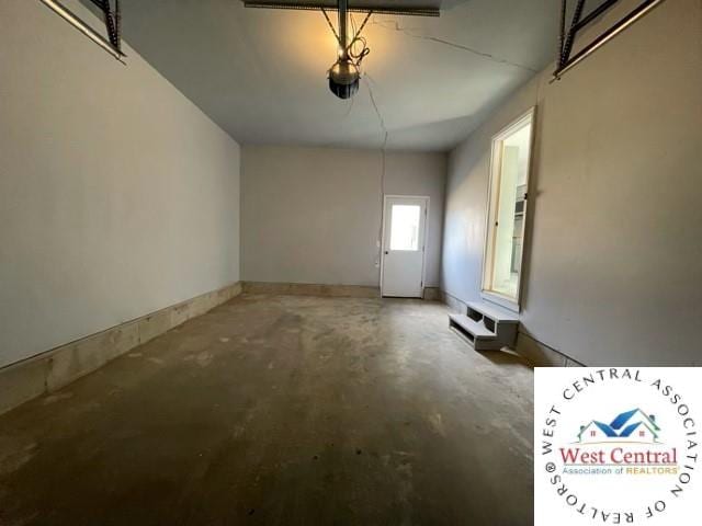 unfurnished dining area featuring baseboards and concrete flooring