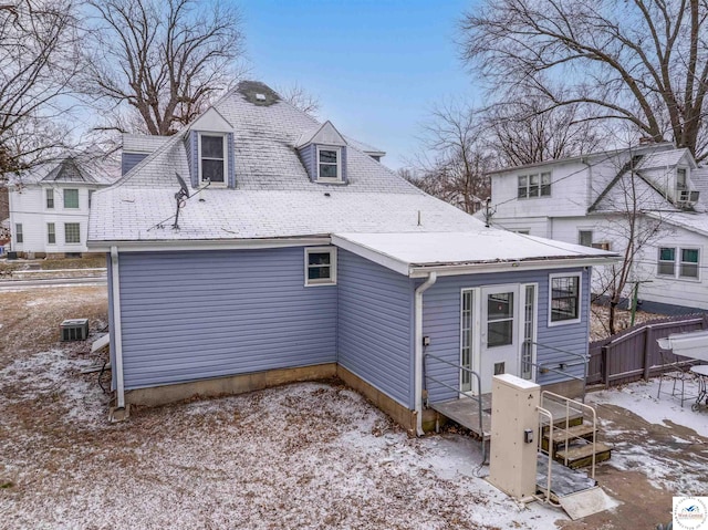 view of snow covered back of property