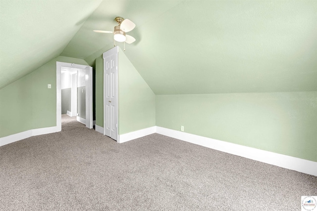 bonus room with carpet floors, lofted ceiling, and baseboards