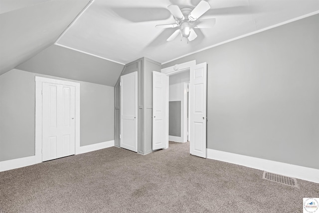 bonus room featuring baseboards, visible vents, vaulted ceiling, and carpet flooring