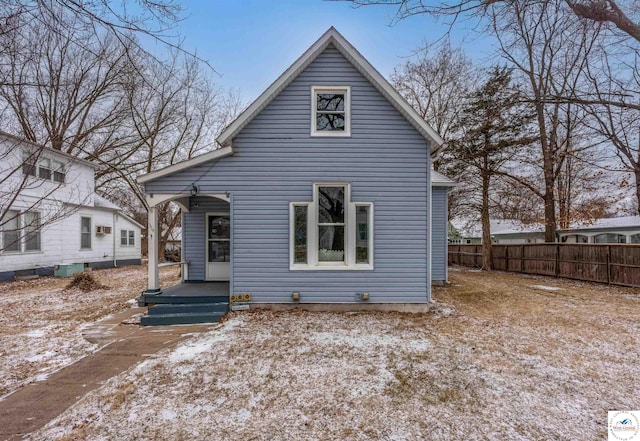 back of house with fence