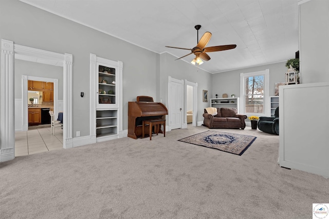 carpeted living area featuring a ceiling fan