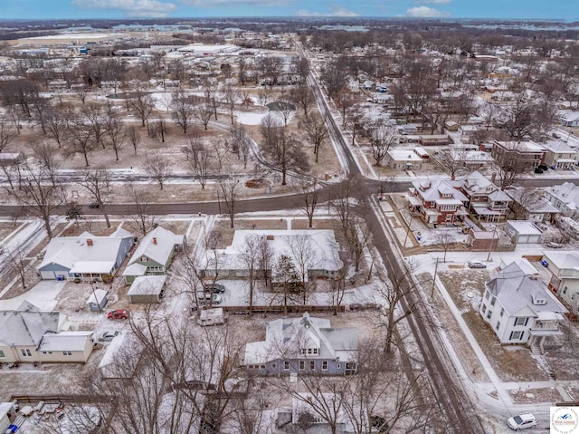 snowy aerial view with a residential view