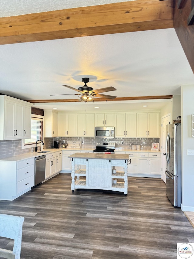 kitchen with a sink, stainless steel appliances, light countertops, and white cabinets