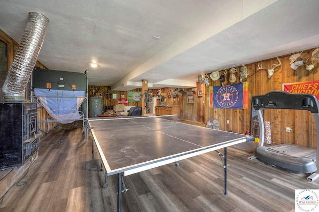 playroom with wood walls and wood finished floors