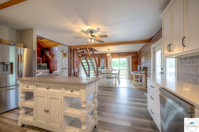 kitchen with stainless steel appliances, light countertops, dark wood-style floors, and white cabinetry