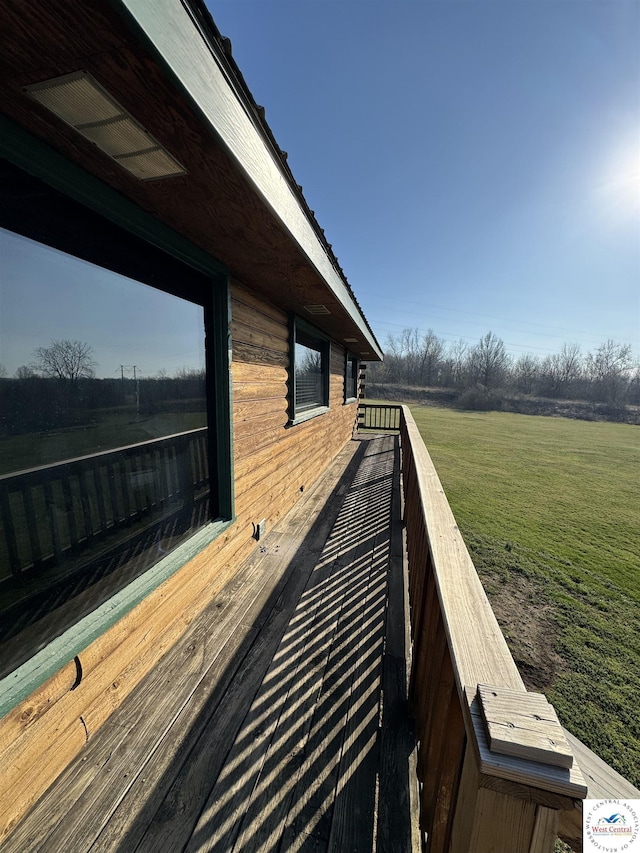 view of side of home with a rural view and a lawn