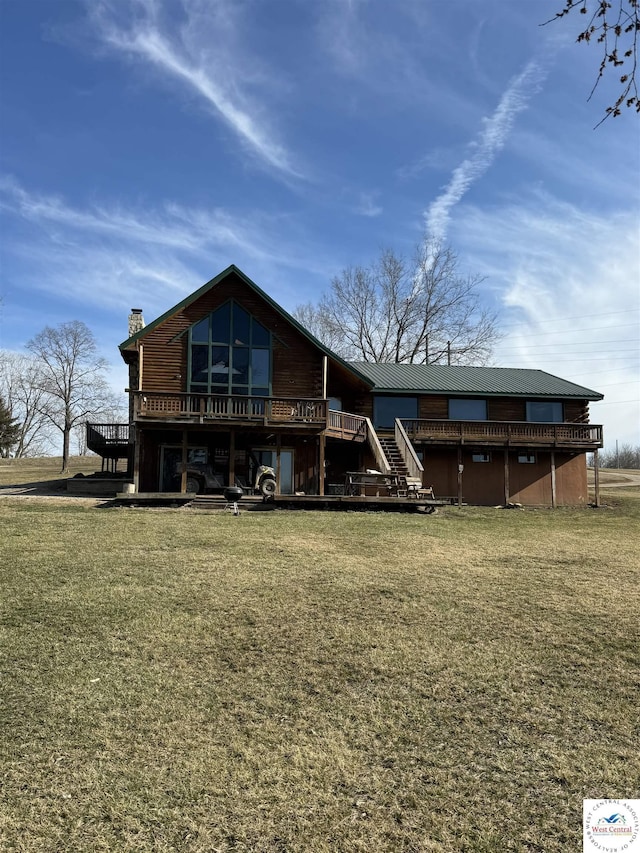 back of property featuring a yard, a chimney, stairway, and a wooden deck