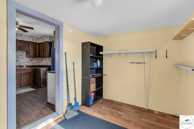 interior space with a ceiling fan and a sink