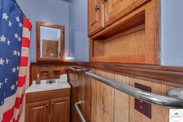 bathroom with wood walls and vanity