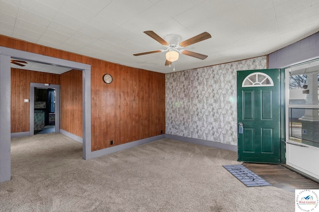 interior space with a ceiling fan and baseboards