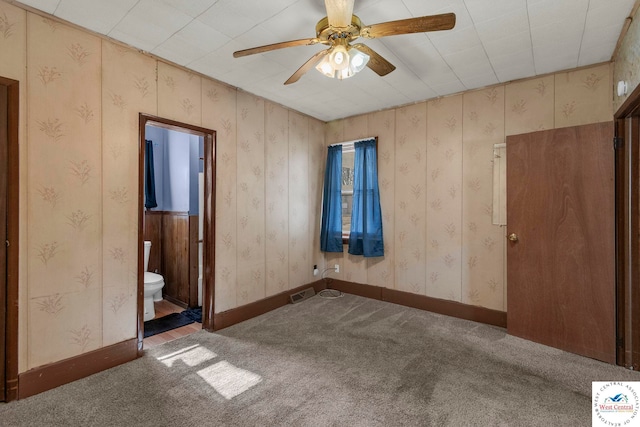 unfurnished bedroom featuring baseboards, carpet floors, and wallpapered walls