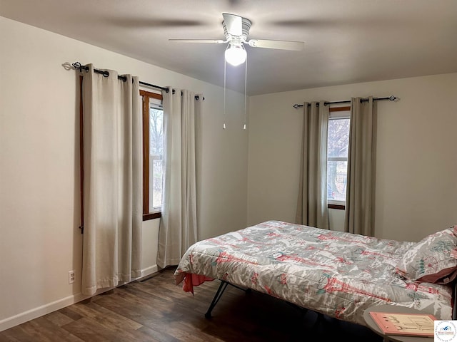 bedroom featuring dark wood-style flooring, ceiling fan, and baseboards