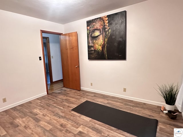 empty room with baseboards and wood finished floors