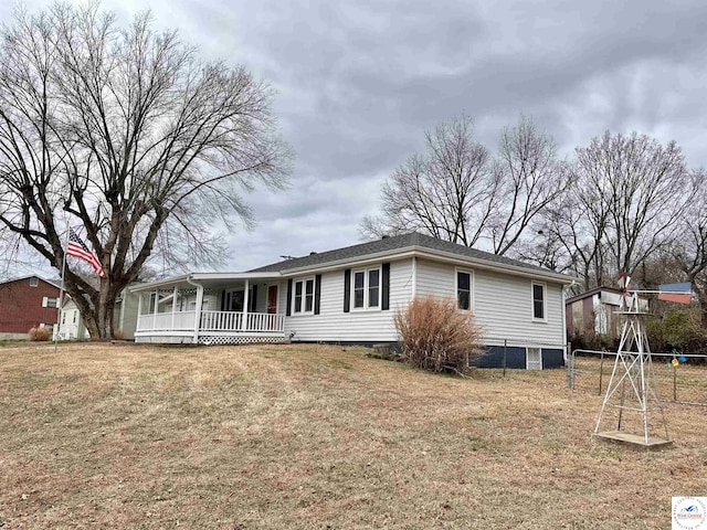 view of front of home with covered porch and a front lawn