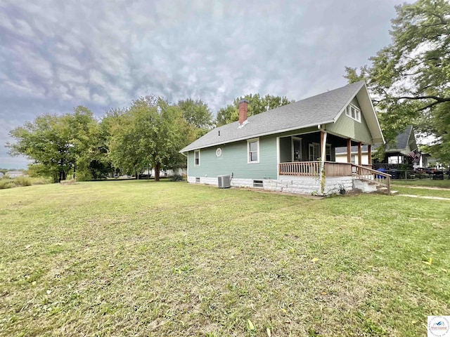 view of property exterior featuring a shingled roof, a chimney, a yard, central air condition unit, and a porch