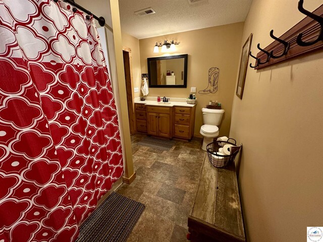 bathroom featuring a textured ceiling, toilet, visible vents, vanity, and a shower with curtain