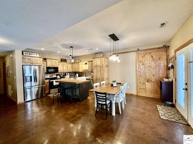 kitchen with tasteful backsplash, light brown cabinets, appliances with stainless steel finishes, and a sink