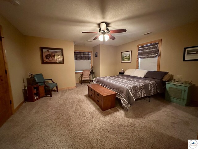 bedroom featuring light carpet, baseboards, visible vents, and ceiling fan