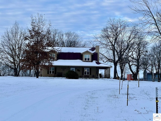 country-style home featuring board and batten siding and a chimney