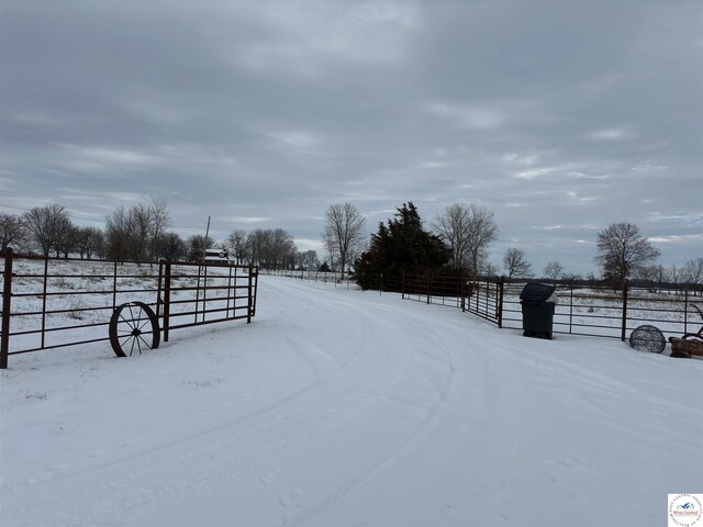 yard covered in snow featuring fence