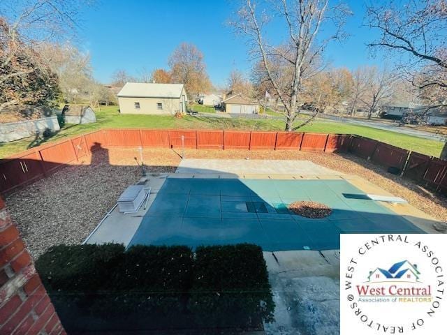 view of swimming pool featuring a lawn, a fenced backyard, and a patio area