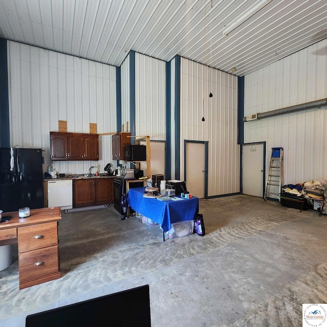 garage with metal wall and freestanding refrigerator