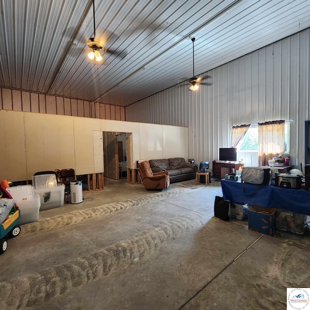 living area featuring ceiling fan, concrete floors, and metal wall