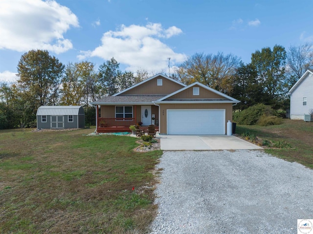 view of front of house with a porch, an attached garage, an outdoor structure, driveway, and a front lawn