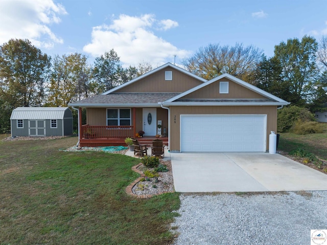 view of front of house featuring covered porch, an attached garage, a front yard, an outdoor structure, and driveway