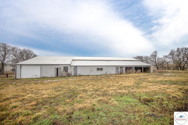 exterior space with fence and a lawn