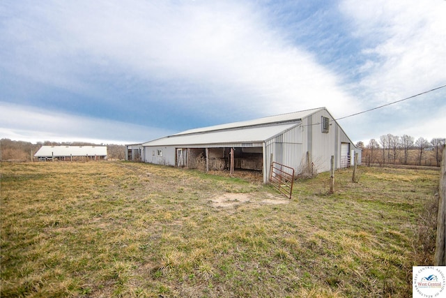 exterior space featuring a garage, a pole building, and an outdoor structure