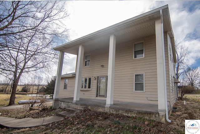 rear view of property with a porch