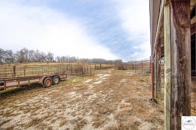 view of yard with a rural view and fence