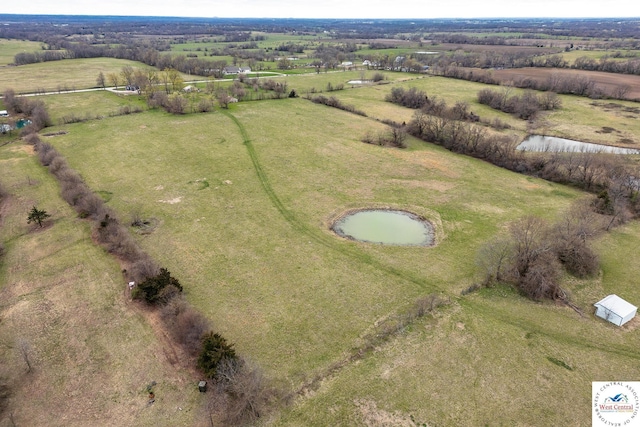 drone / aerial view featuring a rural view and a water view