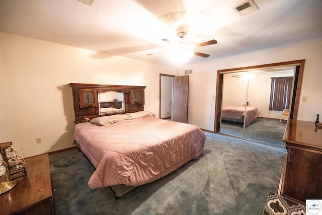 bedroom with ceiling fan, visible vents, dark colored carpet, and a closet