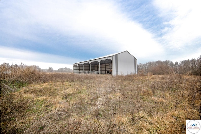 view of pole building with a rural view