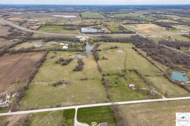 bird's eye view with a water view and a rural view