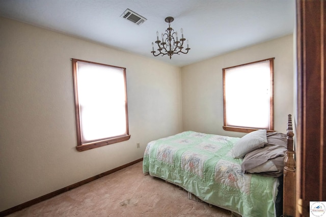 bedroom featuring a chandelier, visible vents, baseboards, and multiple windows